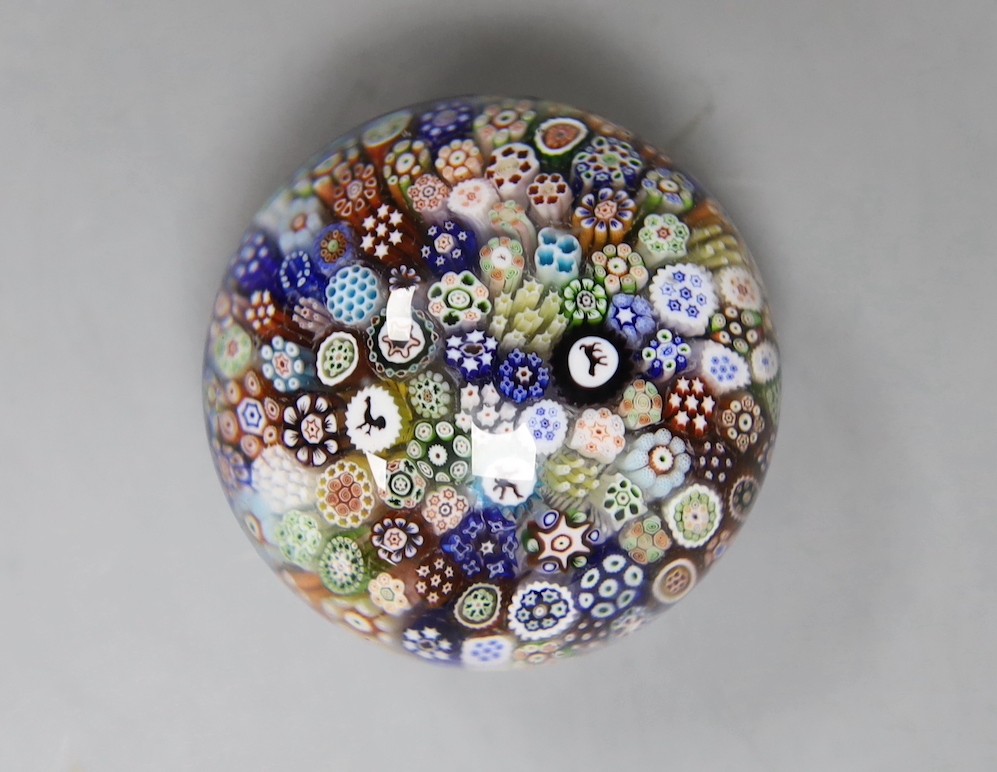 A Baccarat millefiori paperweight, with dog, huntsman and cockerel silhouette canes, 4cms wide